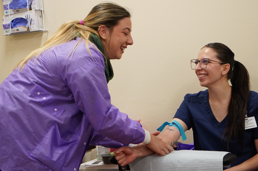 Students practicing to become a phlebotomist in Texas.