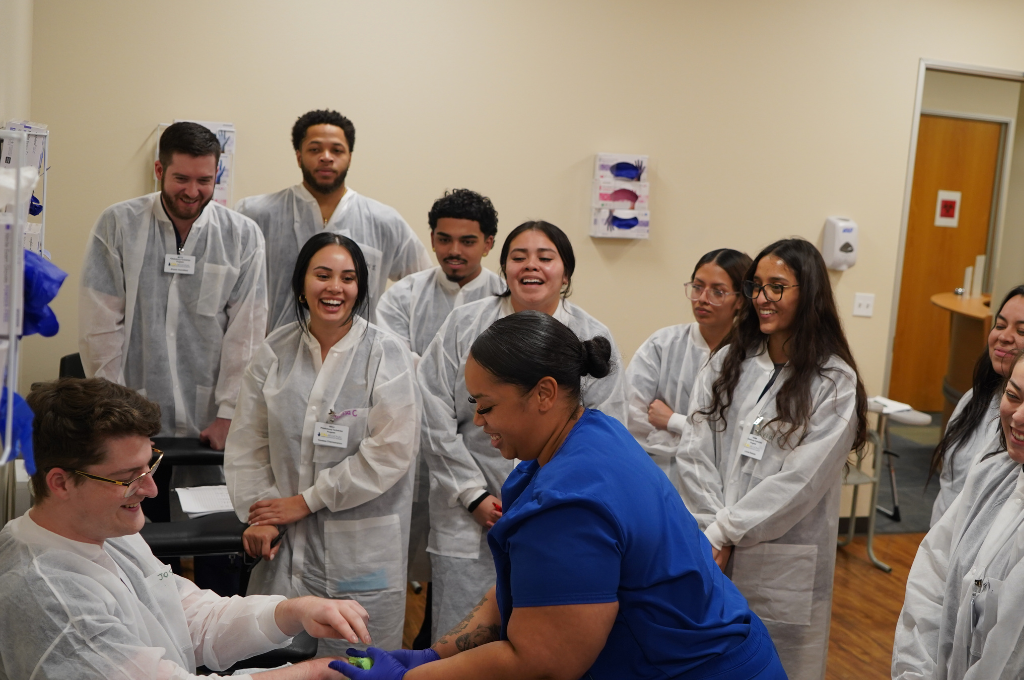 Class practices blood draws to become a phlebotomist in Texas.