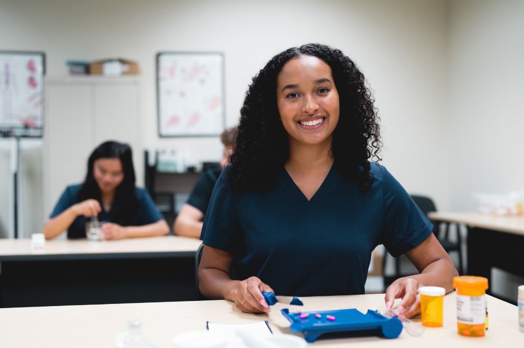 A pharmacy technician student counting pills.