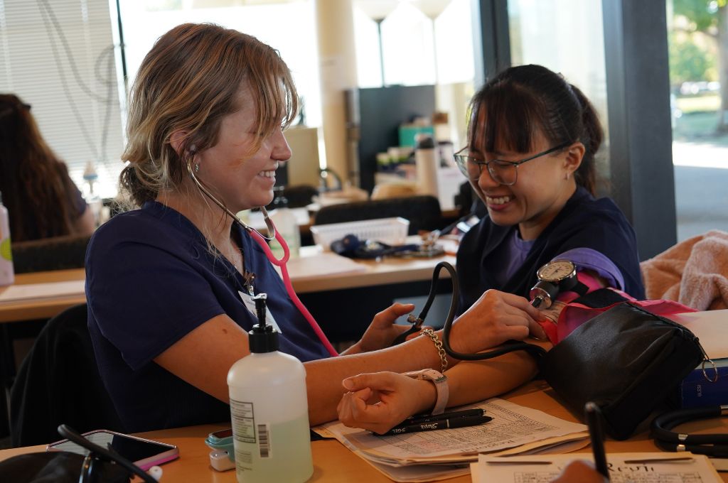 CALRegional students practice medical assistant duties in lab.