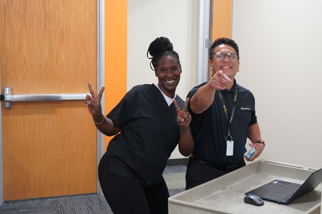 Phlebotomy training instructor and student have fun in class.