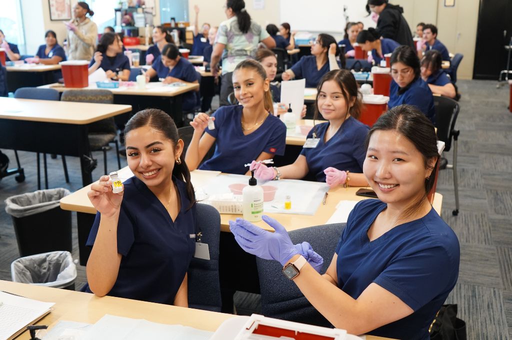 Students take a photo in medical assistant school.