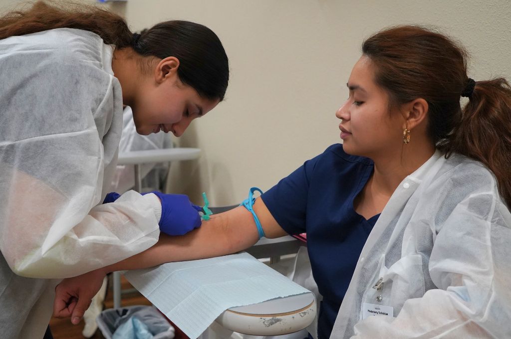 A phlebotomy tech takes a blood draw.