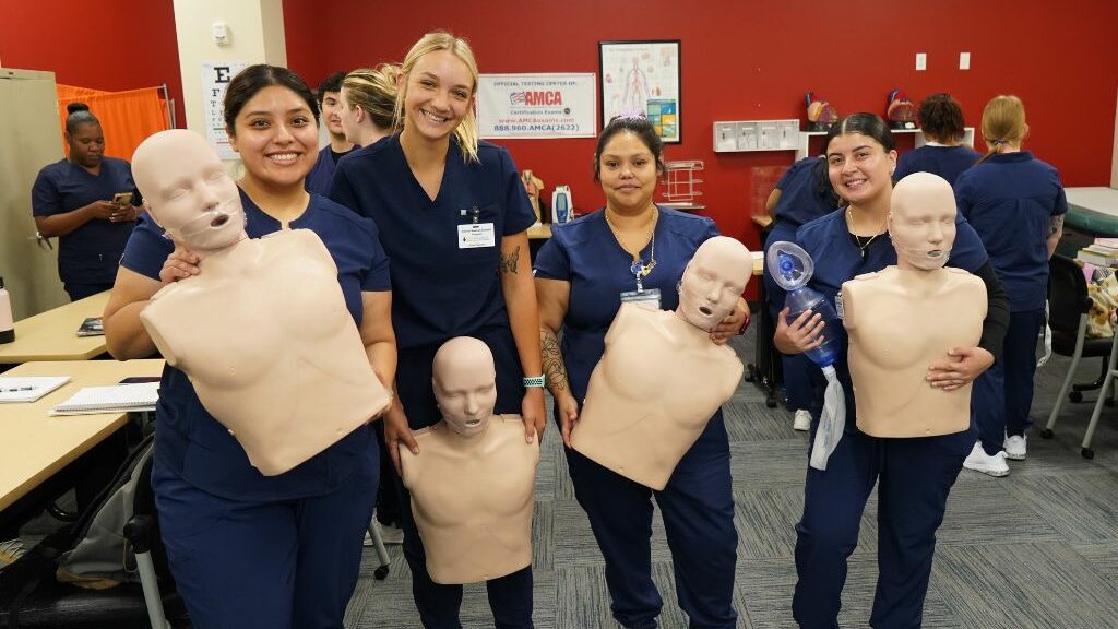 Medical assistant school students practice interacting with patients.