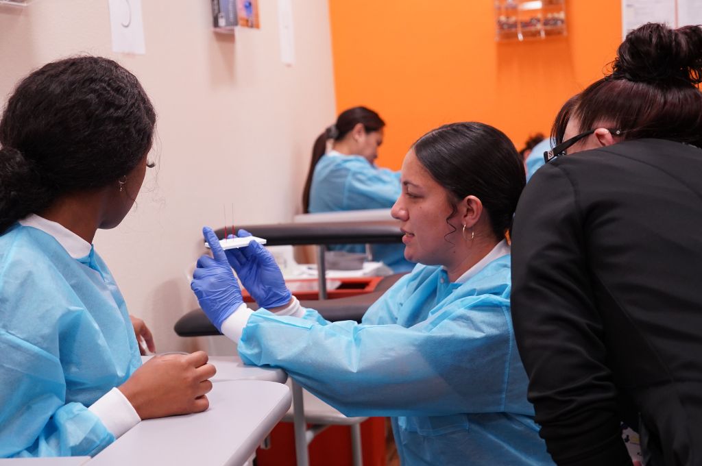 Phlebotomy trainee preparing blood collection materials during CALRegional training near Anaheim, CA.