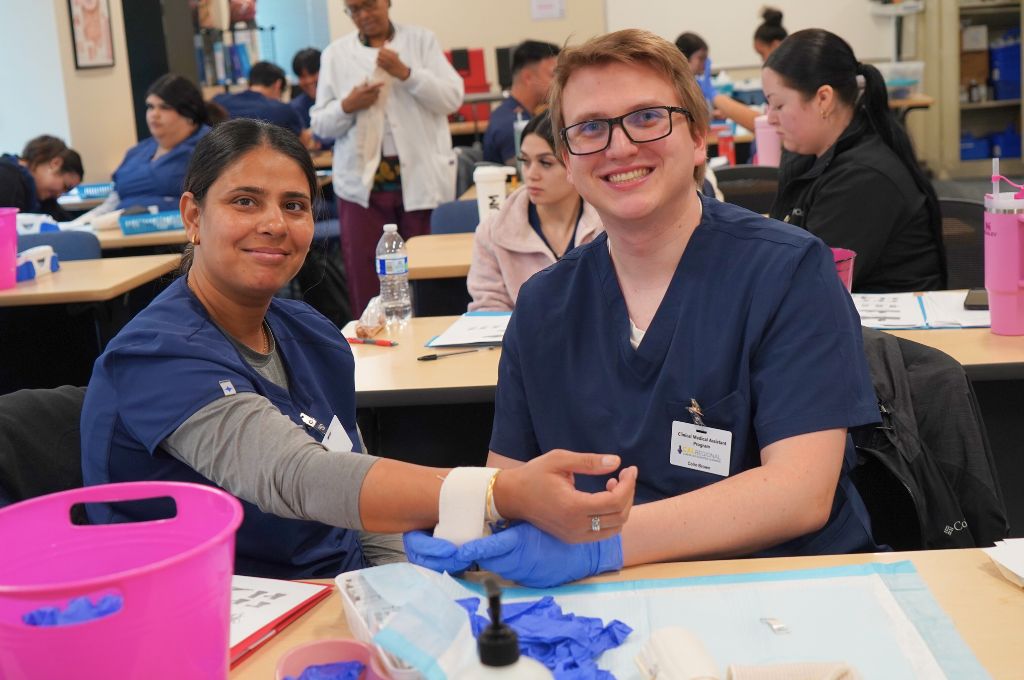 Medical assistant students practicing blood pressure checks during clinical lab training near San Bernardino