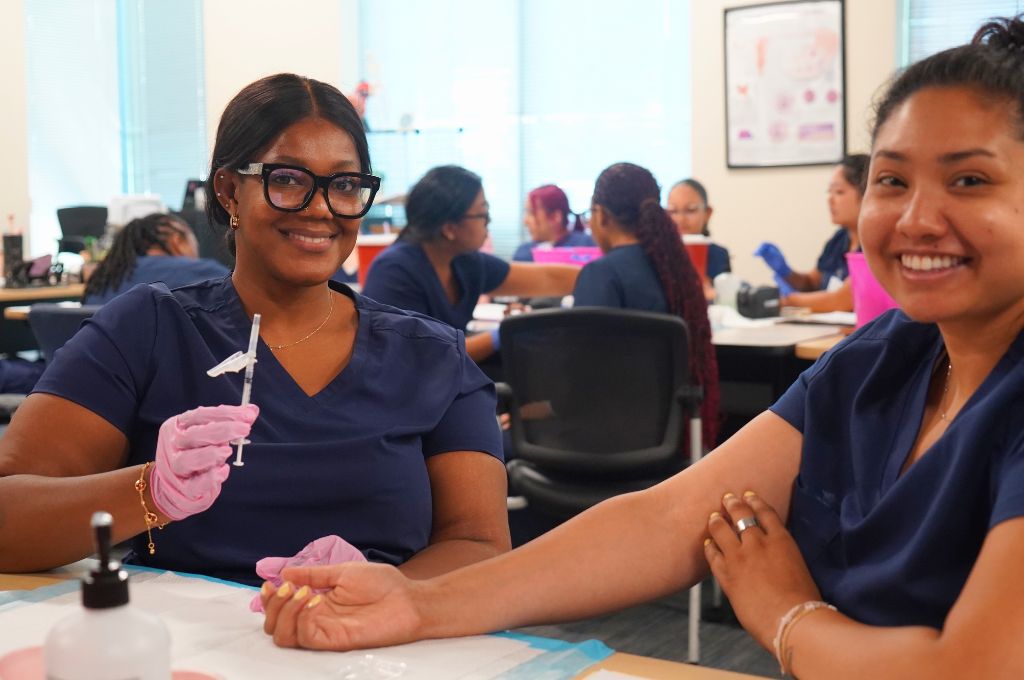 Medical assistant students practicing injection technique during lab training